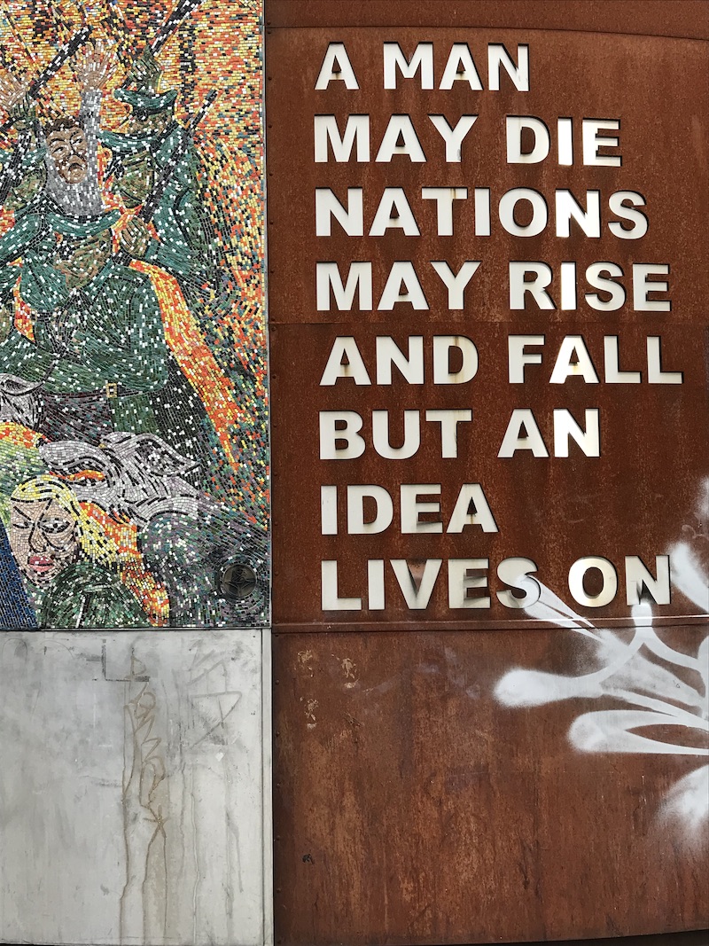 Sign saying "A man may die, nations may rise and fall but an idea lives on"