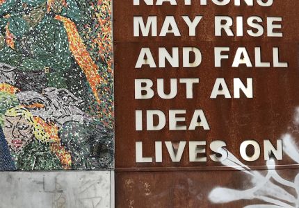 Sign saying "A man may die, nations may rise and fall but an idea lives on"
